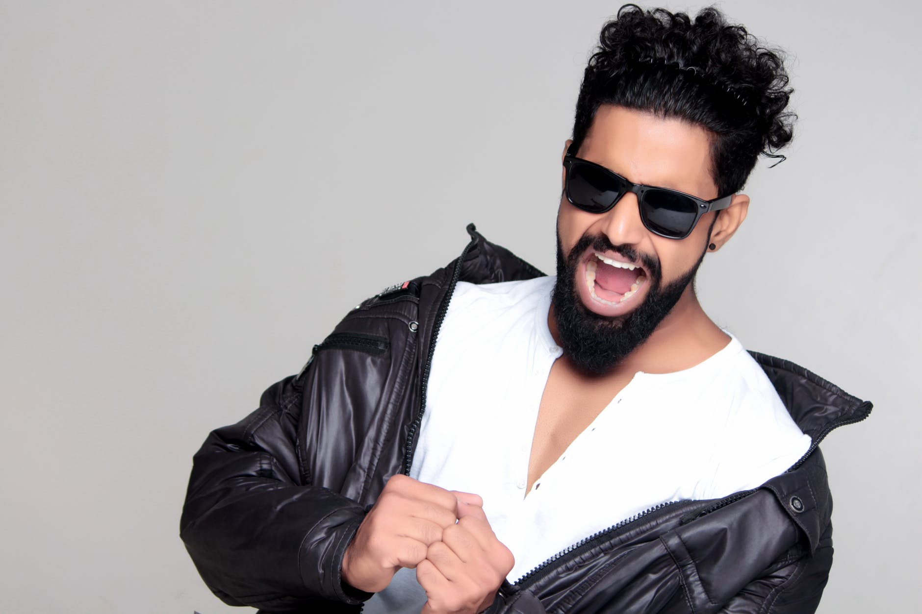 black haired man wearing black sunglasses and black leather jacket