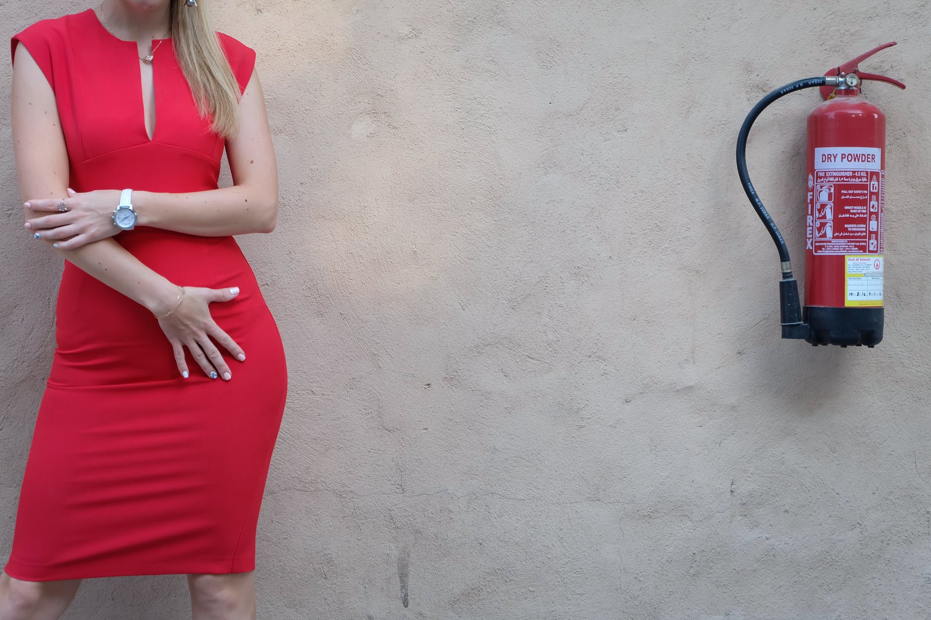 woman standing beside fire extinguisher